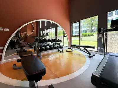 a gym with a large elliptical room with tread machines at Stylish Tropical l 2BR - Ultra Fast Wifi - Sathorn in Bangkok