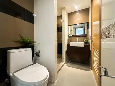 a bathroom with a toilet and a sink at Contemporary Premier 1BR - Ultra Fast Wifi - BTS Nana in Bangkok