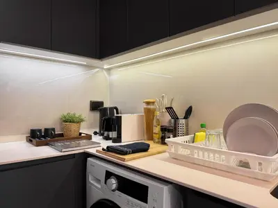 a kitchen with a dish rack on top of a washing machine at Contemporary Downtown - Ultra Fast WiFi - BTS Asoke in Bangkok