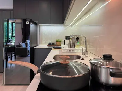 a kitchen with a large pot on a stove at Contemporary Downtown - Ultra Fast WiFi - BTS Asoke in Bangkok