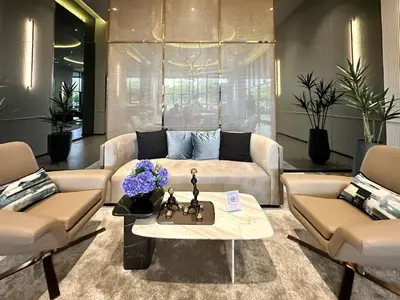 a living room with a couch and a table at Refined High-Rise 1BR - Fast Wifi - BTS Phra Khanong in Bangkok