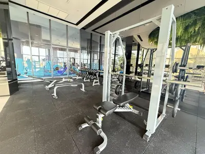 a gym with a bunch of machines in a room at Refined High-Rise 1BR - Fast Wifi - BTS Phra Khanong in Bangkok