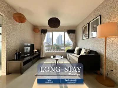 a longstay living room with a couch and a tv at Artsy Luxury 52SQM - Ultra Fast WiFi - BTS Thonglor in Bangkok