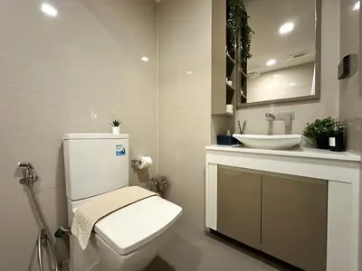 a bathroom with a white toilet and a sink at Stylish Downtown 1BR - Ultra Fast WiFi - BTS ThongLor in Bangkok