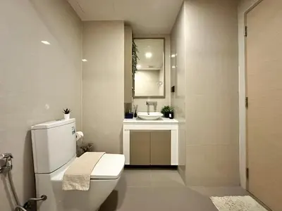 a bathroom with a toilet and a sink at Stylish Downtown 1BR - Ultra Fast WiFi - BTS ThongLor in Bangkok