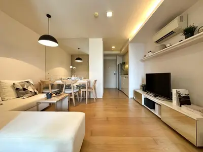 a living room with a bed and a dining room at Stylish Downtown 1BR - Ultra Fast WiFi - BTS ThongLor in Bangkok