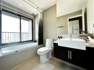 a bathroom with a toilet and a sink and a bath tub at Exclusive Cityscape - Ultra Fast WiFi - BTS Thong Lor in Bangkok