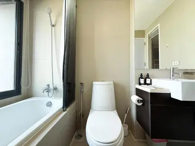 a bathroom with a toilet and a tub and a sink at Exclusive Cityscape - Ultra Fast WiFi - BTS Thong Lor in Bangkok