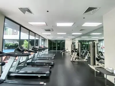a gym with a row of treadmills and machines at Exclusive Cityscape - Ultra Fast WiFi - BTS Thong Lor in Bangkok