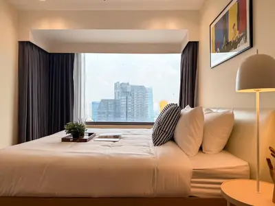 a bedroom with a large bed with a window at Spacious High Rise 2BR - Ultra Fast Wifi - Phrom Phong in Bangkok