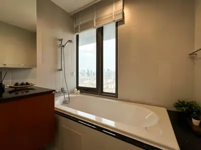 a white bath tub in a kitchen with a window at Spacious High Rise 2BR - Ultra Fast Wifi - Phrom Phong in Bangkok