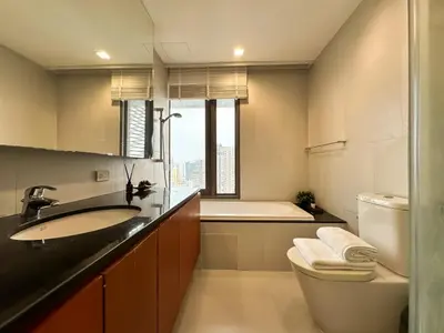 a bathroom with a sink and a toilet and a tub at Spacious High Rise 2BR - Ultra Fast Wifi - Phrom Phong in Bangkok
