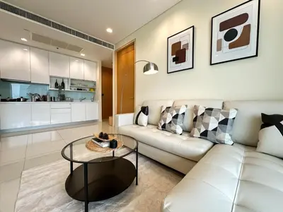 a living room with a white couch and a table at Spacious High Rise 2BR - Ultra Fast Wifi - Phrom Phong in Bangkok
