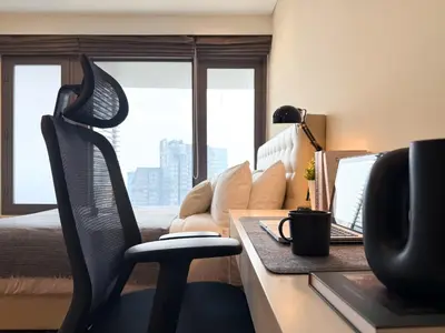 a bedroom with a desk with a computer and a bed at Spacious High Rise 2BR - Ultra Fast Wifi - Phrom Phong in Bangkok