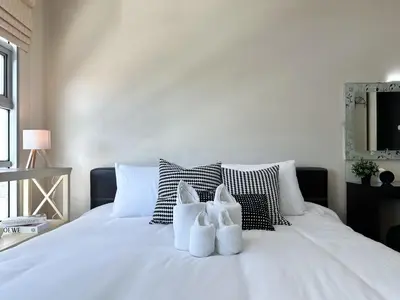 a white bed with two white towels on it at Centralized High-Rise - Ultra Fast Wifi - Ratchathewi in Bangkok