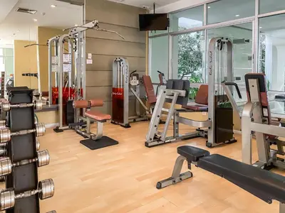 a gym with a bunch of treadmills and machines at Contemporary Modern 1BR - Ultra Fast WiFi - On nut in Bangkok
