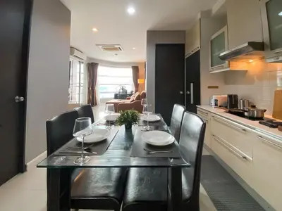 a dining room and kitchen with a table and chairs at Upscale Modern 2BR - Ultra Fast WiFi - BTS Asoke in Bangkok
