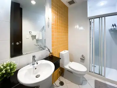 a bathroom with a sink and a toilet at Upscale Modern 2BR - Ultra Fast WiFi - BTS Asoke in Bangkok