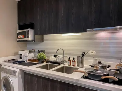 a kitchen with a sink and a dishwasher at Stylish Exquisite 1BR in Bangkok