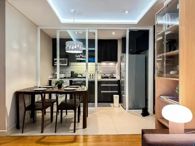 a kitchen and dining room with a table and chairs at Stylish Exquisite 1BR in Bangkok