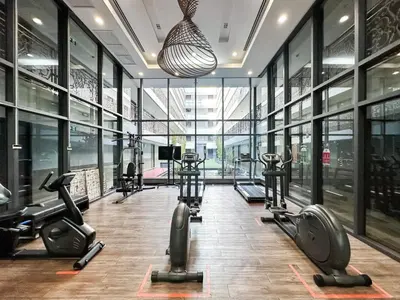 a gym with several treadmills and elliptical machines at Stylish Exquisite 1BR in Bangkok
