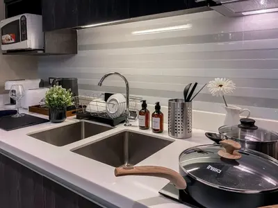a kitchen counter with a sink and a sink at Stylish Exquisite 1BR in Bangkok