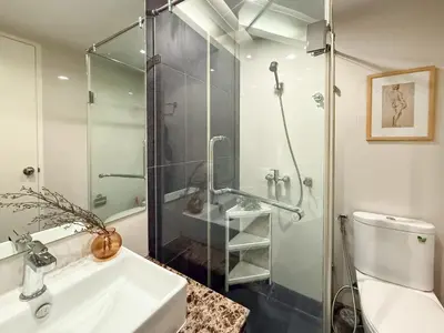 a bathroom with a shower and a sink and a toilet at Ruamrudee Modern - Ultra Fast WiFi - BTS Ploenchit in Bangkok