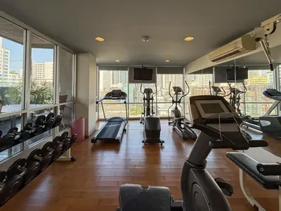 a gym with several treadmills and exercise bikes at Ruamrudee Modern - Ultra Fast WiFi - BTS Ploenchit in Bangkok