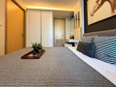 a bedroom with a large bed with a table on it at Stylish Premier 1BR - Ultra Fast Wifi - BTS Nana in Bangkok