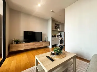 a living room with a large flat screen tv at Contemporary Stylish 1BR - Ultra Fast Wifi - Silom in Bangkok