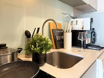 a kitchen with a sink and a counter top with a sink at Contemporary Stylish 1BR - Ultra Fast Wifi - Silom in Bangkok