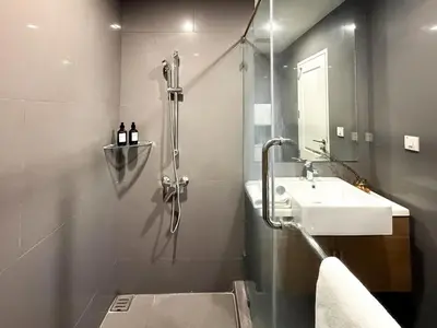 a bathroom with a shower and a sink at Contemporary Stylish 1BR - Ultra Fast Wifi - Silom in Bangkok
