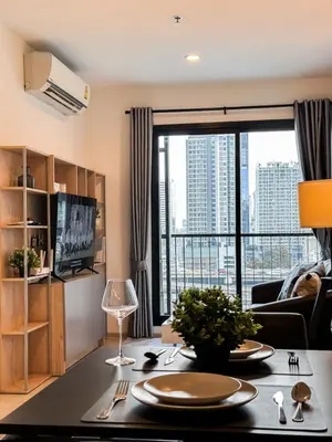 a living room with a table and a large window at Luxury City-Scape 2BR - Ultra Fast Wifi - Asoke in Bangkok