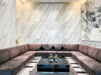 a brown couch with a table in a room at Luxury City-Scape 2BR - Ultra Fast Wifi - Asoke in Bangkok