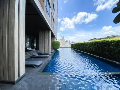 a swimming pool in the middle of a building at Cityscape Modern Apt - Ultra Fast Wifi - Phra Khanong in Bangkok