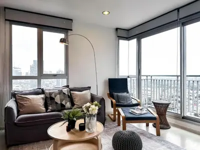 a living room with a couch and a table at Contemporary High-Rise 2BR - Ultra Fast Wifi - Sathorn in Bangkok