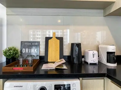 a kitchen counter with a counter top with a sink at Contemporary High-Rise 2BR - Ultra Fast Wifi - Sathorn in Bangkok