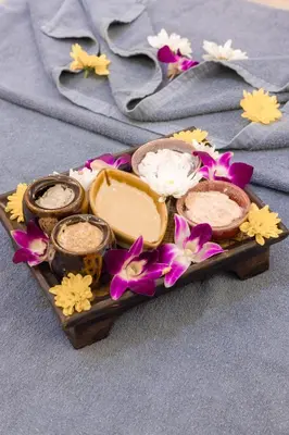 a tray with various types of soap and flowers at Avana Bangkok Hotel & Convention Centre in Bangna