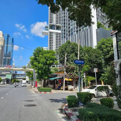 a street in a city with a tall building at City Living in Bangkok