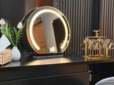 a vanity with a mirror and a vase of flowers at Delta9 Phrakanong 3 mins BTS Phrakanong in Bangkok