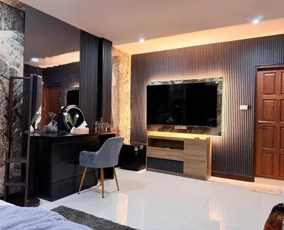 a bedroom with a desk and a large screen television at Delta9 Phrakanong 3 mins BTS Phrakanong in Bangkok