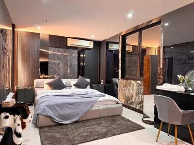 a bedroom with a large bed and a desk at Delta9 Phrakanong 3 mins BTS Phrakanong in Bangkok