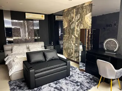 a bedroom with a bed and a couch and a chair at Delta9 Phrakanong 3 mins BTS Phrakanong in Bangkok
