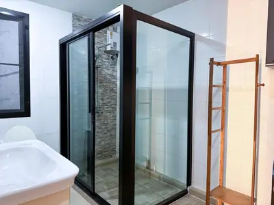 a glass shower in a bathroom with a sink at Delta9 Phrakanong 3 mins BTS Phrakanong in Bangkok
