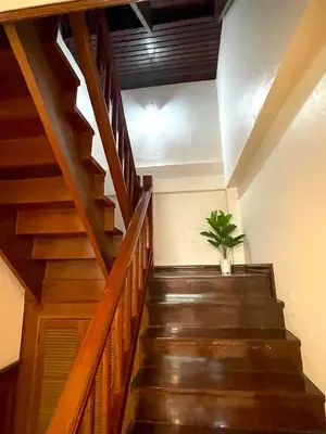 a stairway with a potted plant in a room at TheStarHome Sukhumvit71 in Bangkok