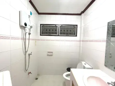 a bathroom with a shower and a toilet and a window at TheStarHome Sukhumvit71 in Bangkok