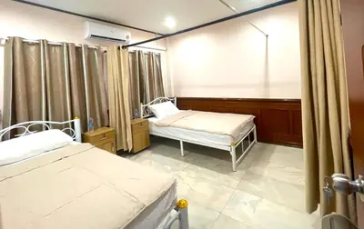 a hospital room with two beds and a window at TheStarHome Sukhumvit71 in Bangkok