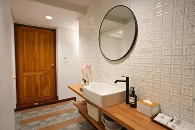 a bathroom with a sink and a mirror on the wall at 2BR 1BA Home In Yaowarat 5 Min MRT Nivas Wanit ECO in Bangkok