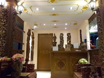 a lobby with a door and some sculptures on the ceiling at Kim Hotel At Morleng in Bangkok