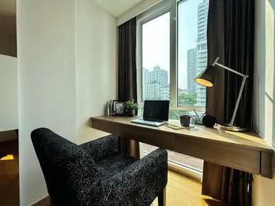 a room with a desk with a laptop and a window at Contemporary Premier 1BR - Ultra Fast Wifi - BTS Nana in Bangkok